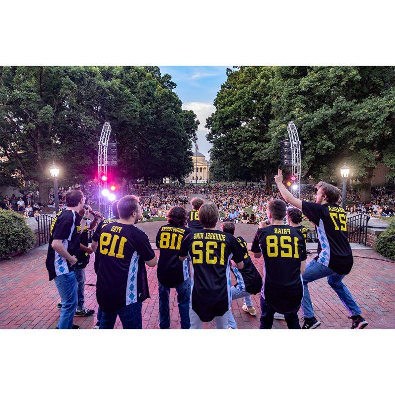 An a cappella group singing to an audience of students on the campus of UNC-Chapel Hill.